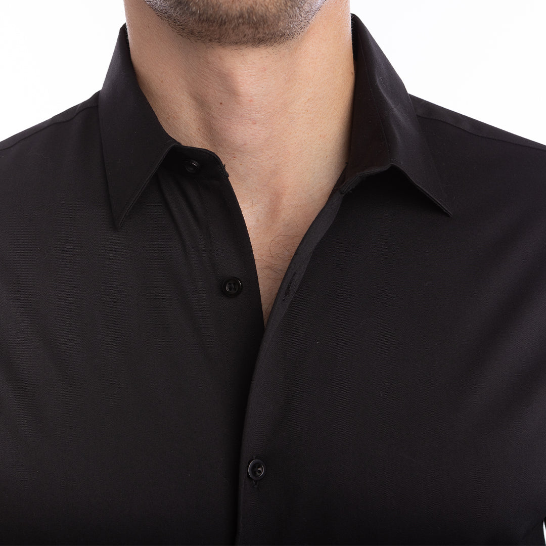 Structured black shirt with built-in collar support made for confident evening wear with an open collar.