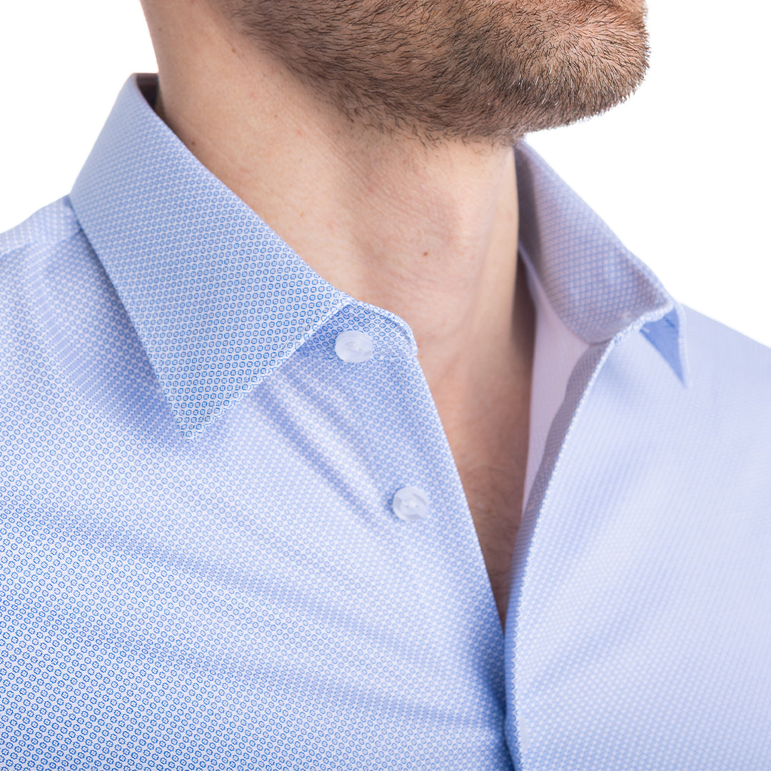 Blue dress shirt worn with two buttons undone — holds its shape thanks to hidden Million Dollar Collar stays.